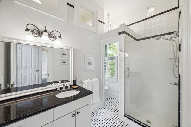 607 11th St, Galveston, TX 77550 - bathroom with a shower stall, vanity, and a chandelier