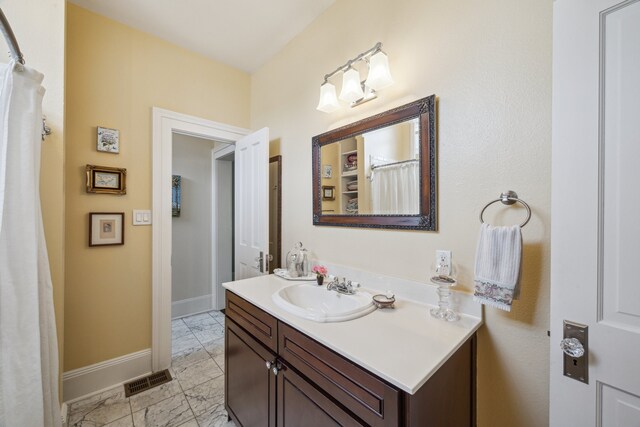 607 11th St, Galveston, TX 77550 - full bathroom featuring marble finish flooring and vanity