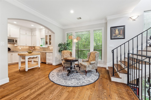 234 Knox St, Houston, TX 77007 - dining space with light wood-style flooring, arched walkways, ornamental molding, stairs, and recessed lighting