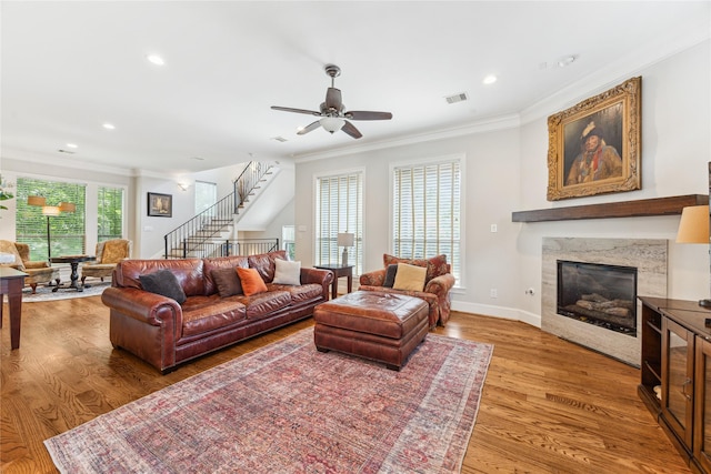 234 Knox St, Houston, TX 77007 - living area featuring crown molding, wood finished floors, a premium fireplace, stairway, and a ceiling fan
