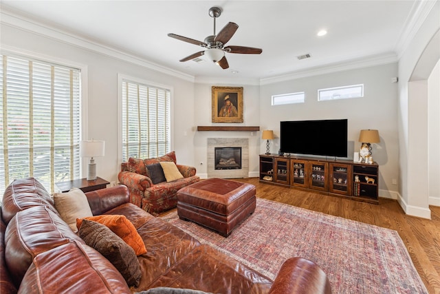 234 Knox St, Houston, TX 77007 - living area featuring healthy amount of natural light, ornamental molding, a fireplace, ceiling fan, and wood finished floors