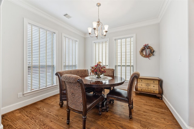 234 Knox St, Houston, TX 77007 - dining room featuring a chandelier, crown molding, and wood finished floors