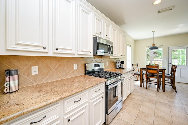 28503 Cece Glen Ct, Spring, TX 77386 - kitchen featuring stainless steel appliances, light tile patterned flooring, decorative backsplash, and recessed lighting