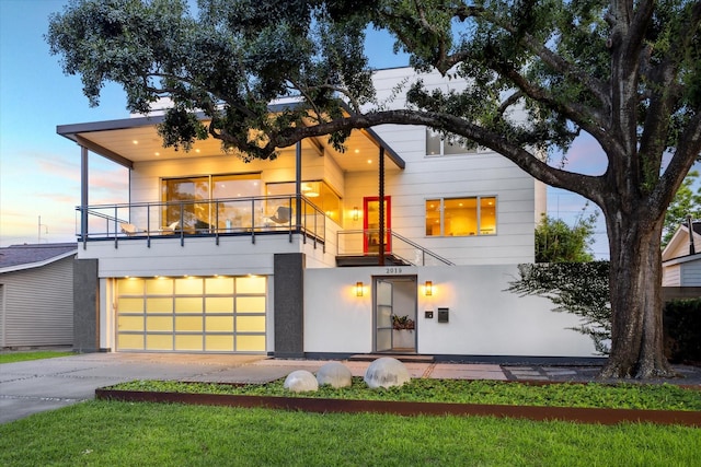 2019 Du Barry Ln, Houston, TX 77018 - contemporary home with a balcony, concrete driveway, and a garage
