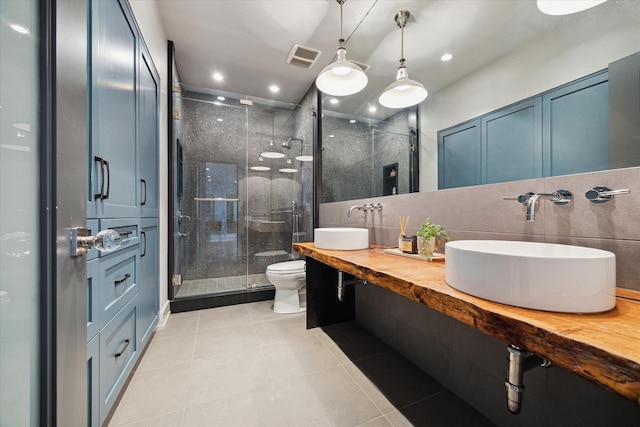 2019 Du Barry Ln, Houston, TX 77018 - bathroom featuring a stall shower, tile patterned floors, double vanity, and recessed lighting