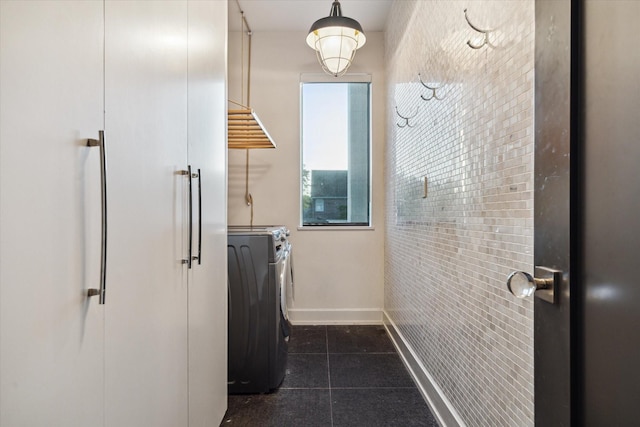2019 Du Barry Ln, Houston, TX 77018 - washroom featuring dark tile patterned floors and baseboards
