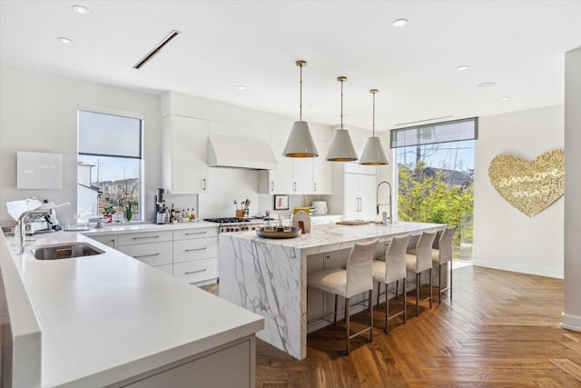 2019 Du Barry Ln, Houston, TX 77018 - kitchen featuring custom range hood, modern cabinets, white cabinetry, healthy amount of natural light, and recessed lighting