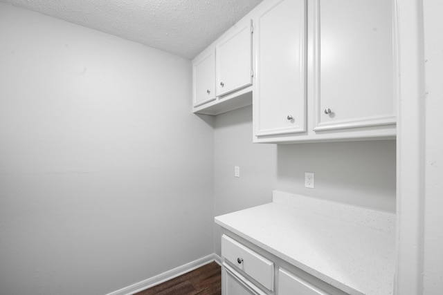 2822 Roseheath Ln, Houston, TX 77073 - laundry room featuring dark wood finished floors and a textured ceiling