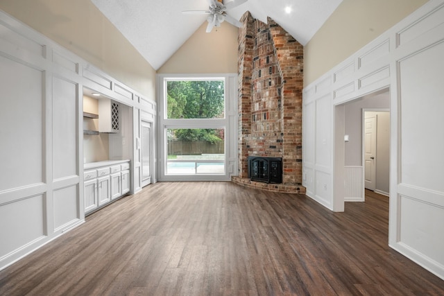 2822 Roseheath Ln, Houston, TX 77073 - unfurnished living room featuring high vaulted ceiling, a decorative wall, a ceiling fan, wood finished floors, and wainscoting