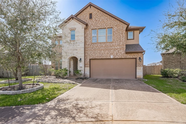 4310 Tilbury Trl, Richmond, TX 77407 - view of front of house with stone siding, a garage, and driveway