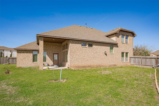 4310 Tilbury Trl, Richmond, TX 77407 - back of property featuring a fenced backyard, a shingled roof, and brick siding