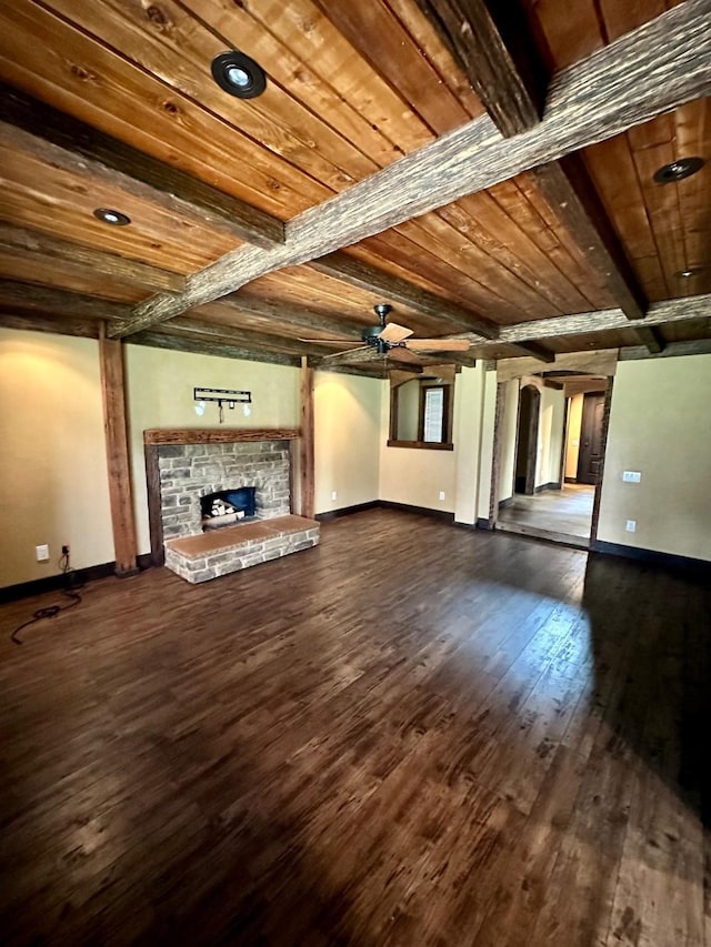 4842 Green Trail Dr, Houston, TX 77084 - unfurnished living room featuring a ceiling fan, dark wood-style flooring, a wood ceiling with exposed beams, and a fireplace