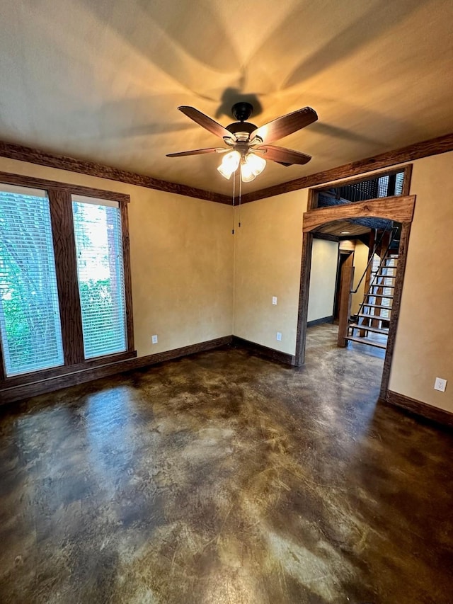 4842 Green Trail Dr, Houston, TX 77084 - spare room featuring concrete flooring, ceiling fan, stairway, and ornamental molding