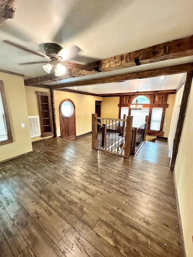 4842 Green Trail Dr, Houston, TX 77084 - unfurnished living room featuring a textured ceiling, ceiling fan, hardwood / wood-style floors, beam ceiling, and plenty of natural light