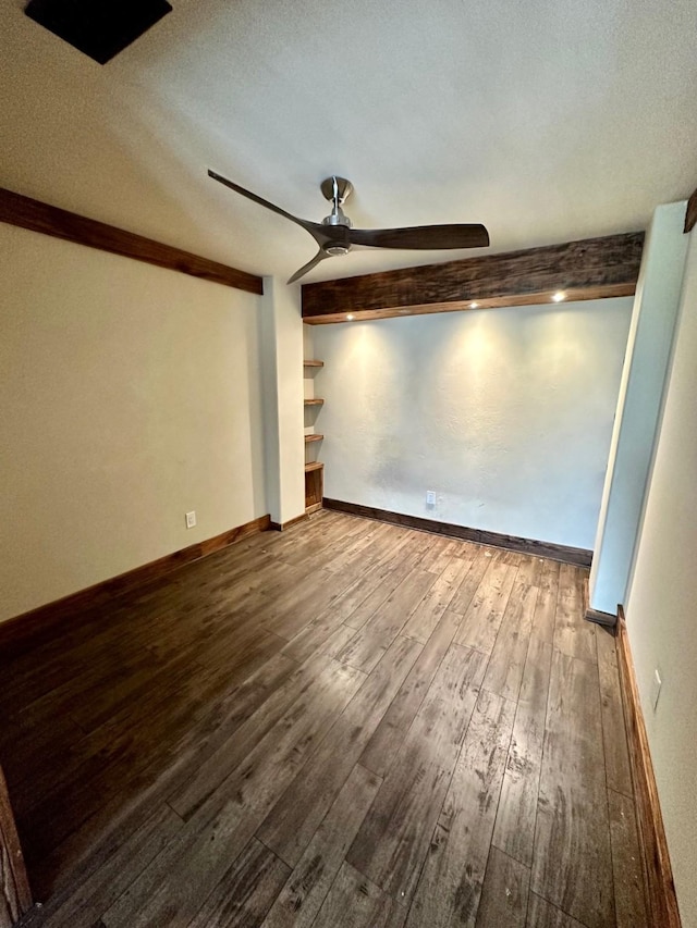 4842 Green Trail Dr, Houston, TX 77084 - empty room featuring a ceiling fan, beam ceiling, dark wood finished floors, and a textured ceiling