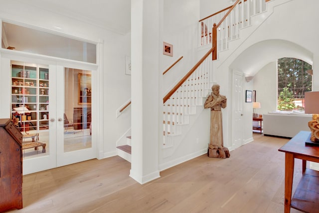 13718 Gainesway Dr, Cypress, TX 77429 - stairway featuring wood finished floors, arched walkways, and french doors
