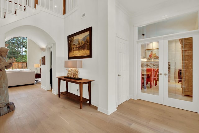 13718 Gainesway Dr, Cypress, TX 77429 - hall with french doors, wood finished floors, arched walkways, ornamental molding, and a high ceiling