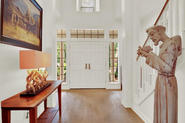 13718 Gainesway Dr, Cypress, TX 77429 - foyer entrance with wood finished floors, a high ceiling, and stairs