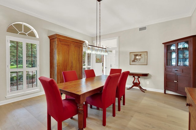13718 Gainesway Dr, Cypress, TX 77429 - dining area featuring light wood finished floors, a chandelier, and crown molding