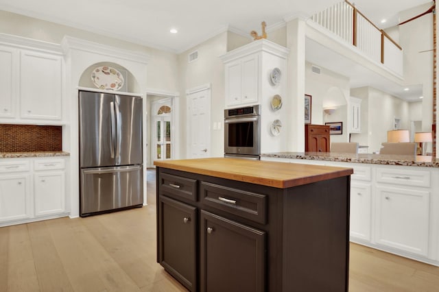 13718 Gainesway Dr, Cypress, TX 77429 - kitchen featuring freestanding refrigerator, butcher block countertops, white cabinets, light wood-style floors, and backsplash