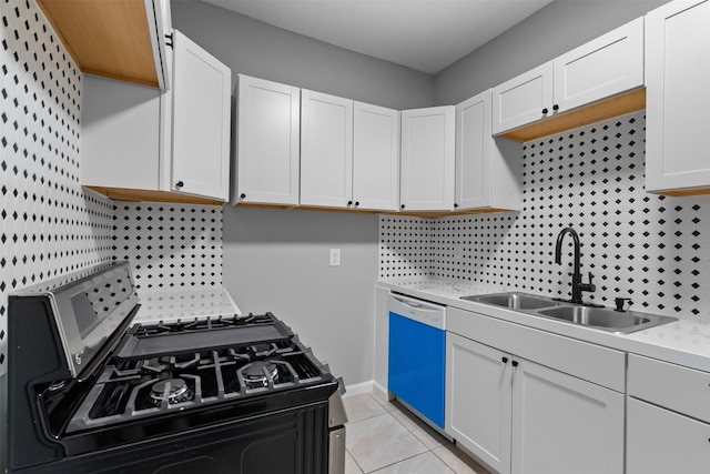 317 11th Ave N, Texas City, TX 77590 - kitchen with gas stove, dishwashing machine, light countertops, white cabinetry, and decorative backsplash