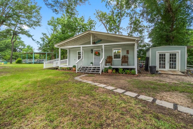 8851 US Highway 59 N, Livingston, TX 77351 - view of front of home featuring french doors, a porch, and a front yard