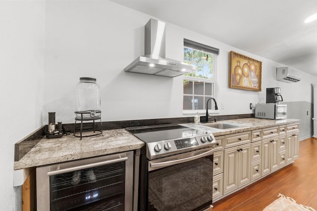 8851 US Highway 59 N, Livingston, TX 77351 - kitchen featuring wall chimney range hood, electric range, cream cabinets, a wall mounted AC, and beverage cooler
