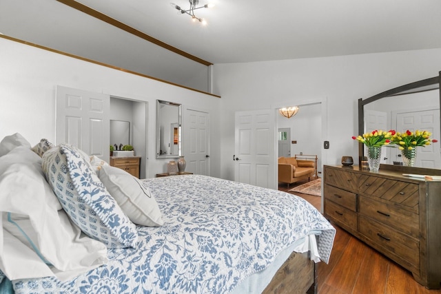 8851 US Highway 59 N, Livingston, TX 77351 - bedroom featuring vaulted ceiling, dark wood finished floors, and a chandelier
