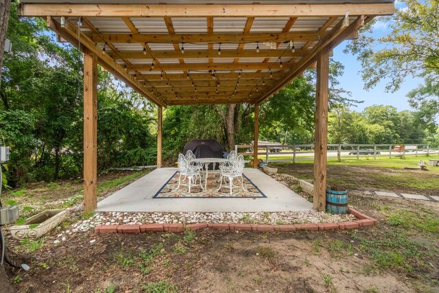 8851 US Highway 59 N, Livingston, TX 77351 - view of patio with view of scattered trees and a grill