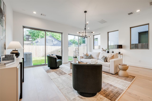 1937 W Clay St, Houston, TX 77019 - living area featuring light wood-type flooring, plenty of natural light, a chandelier, and recessed lighting