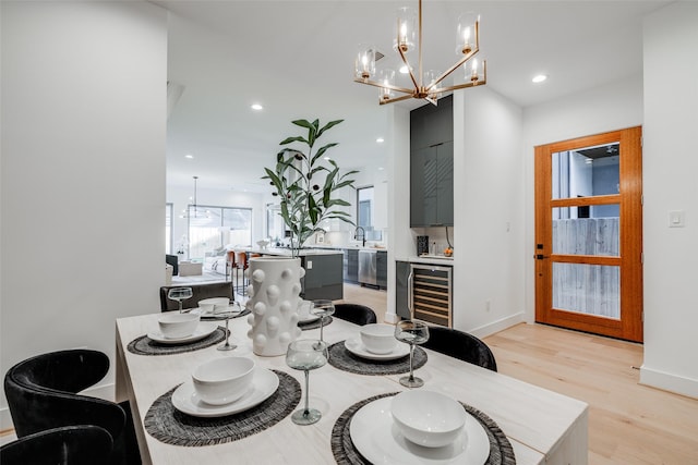 1937 W Clay St, Houston, TX 77019 - dining space with beverage cooler, a chandelier, light wood-type flooring, and recessed lighting