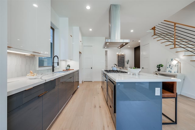 1937 W Clay St, Houston, TX 77019 - kitchen with modern cabinets, range hood, light wood-style floors, white cabinets, and recessed lighting