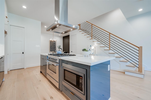 1937 W Clay St, Houston, TX 77019 - kitchen with island range hood, appliances with stainless steel finishes, light wood finished floors, a chandelier, and recessed lighting