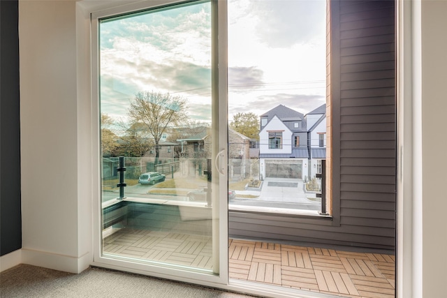 1937 W Clay St, Houston, TX 77019 - doorway to outside featuring baseboards and carpet flooring