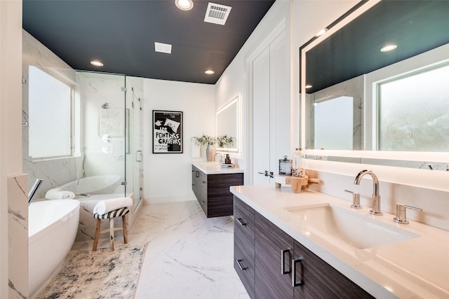 1937 W Clay St, Houston, TX 77019 - bathroom with a marble finish shower, two vanities, a soaking tub, marble finish flooring, and recessed lighting