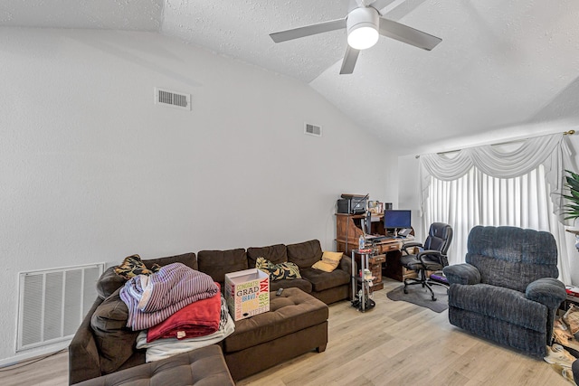 3822 Quiet Place Dr, Houston, TX 77082 - living room with lofted ceiling, light wood-style floors, a ceiling fan, a textured ceiling, and a desk