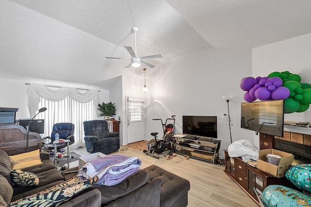 3822 Quiet Place Dr, Houston, TX 77082 - living room featuring lofted ceiling, a ceiling fan, wood finished floors, and a textured ceiling