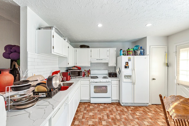 3822 Quiet Place Dr, Houston, TX 77082 - kitchen featuring white appliances, under cabinet range hood, tasteful backsplash, white cabinets, and a textured ceiling