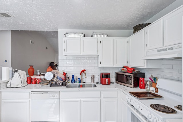 3822 Quiet Place Dr, Houston, TX 77082 - kitchen with white appliances, under cabinet range hood, a textured ceiling, light countertops, and decorative backsplash