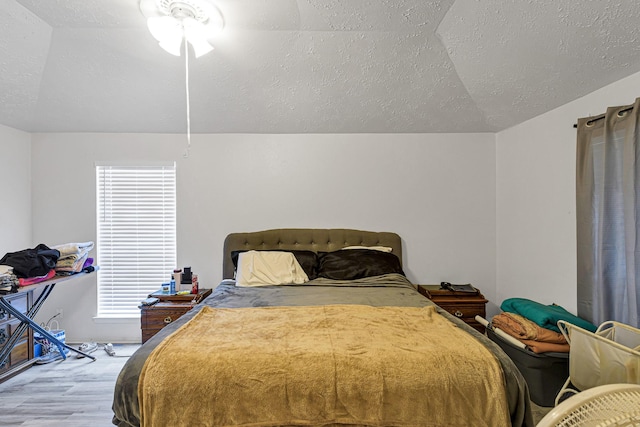 3822 Quiet Place Dr, Houston, TX 77082 - bedroom featuring lofted ceiling, wood finished floors, a textured ceiling, and multiple windows