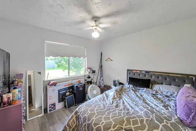 3822 Quiet Place Dr, Houston, TX 77082 - bedroom with wood finished floors, a textured ceiling, and a ceiling fan