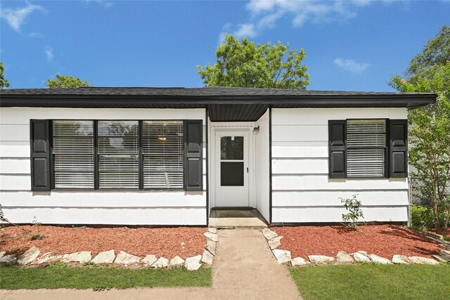 13915 Nitida St, Houston, TX 77045 - view of exterior entry featuring roof with shingles