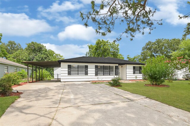 13915 Nitida St, Houston, TX 77045 - view of front facade with driveway, a front yard, and a carport