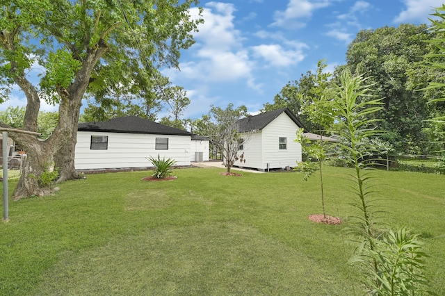 13915 Nitida St, Houston, TX 77045 - view of grassy yard featuring an outdoor structure