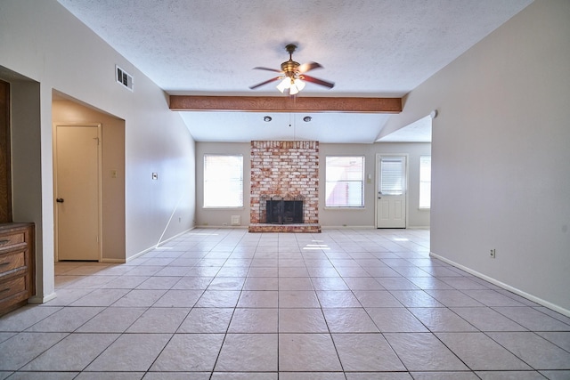 14835 Delbarton Dr, Houston, TX 77083 - unfurnished living room featuring a ceiling fan, a textured ceiling, light tile patterned flooring, a brick fireplace, and beam ceiling