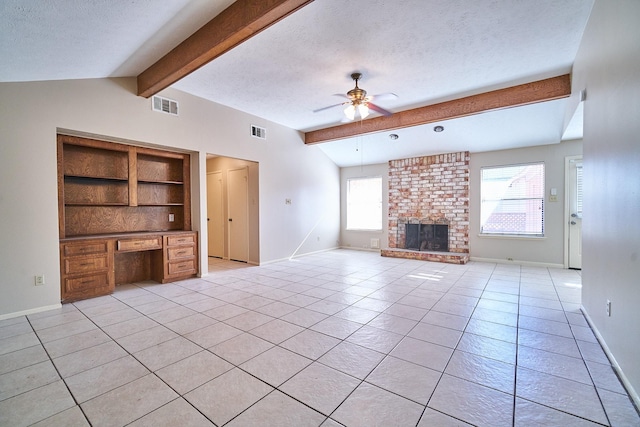 14835 Delbarton Dr, Houston, TX 77083 - unfurnished living room featuring ceiling fan, built in study area, light tile patterned floors, a textured ceiling, and a brick fireplace