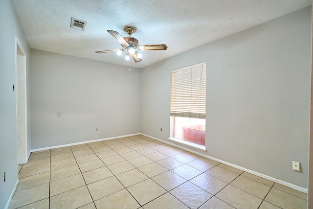 14835 Delbarton Dr, Houston, TX 77083 - spare room featuring ceiling fan, light tile patterned flooring, and a textured ceiling