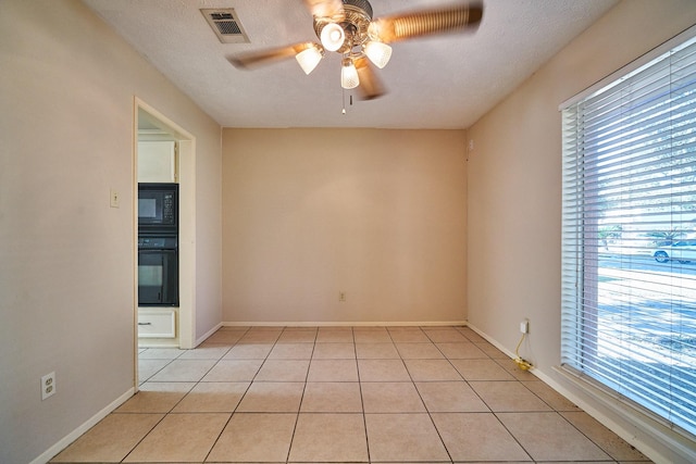 14835 Delbarton Dr, Houston, TX 77083 - unfurnished room featuring a ceiling fan, plenty of natural light, and light tile patterned floors