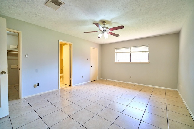 14835 Delbarton Dr, Houston, TX 77083 - unfurnished bedroom featuring a textured ceiling, light tile patterned floors, a ceiling fan, and ensuite bathroom