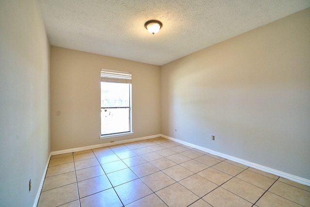 14835 Delbarton Dr, Houston, TX 77083 - empty room featuring light tile patterned floors and a textured ceiling